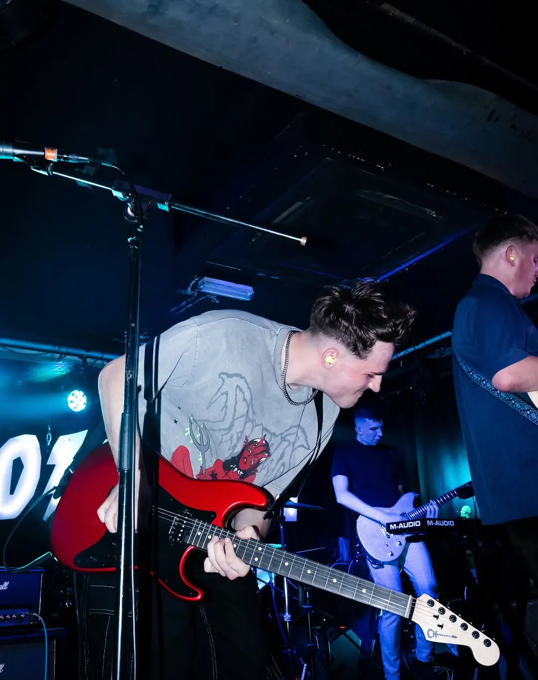 Aidan Mansell playing guitar live