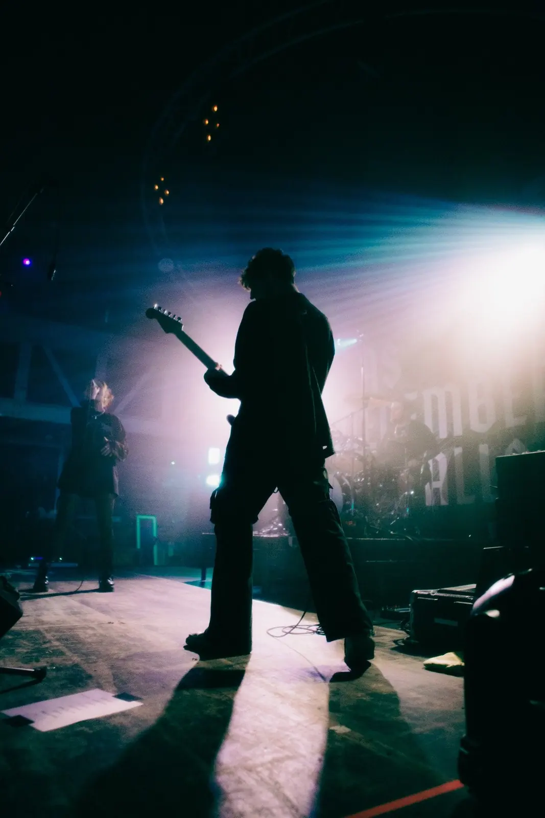 Aidan Mansell silhouetted on stage